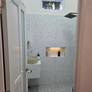 a bathroom with a toilet and a sink and a window at Lamar home in Jakarta