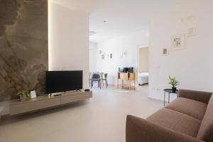a living room with a tv and a couch at ARQO Apartments in Marcianise