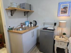 a kitchen with a sink and a counter top at Modern rustic private flat in Bloemfontein