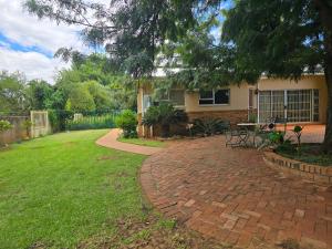 a brick patio in front of a house at Modern rustic private flat in Bloemfontein