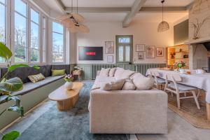 a living room with a couch and a table at La Villa des Coccinelles in Olivet