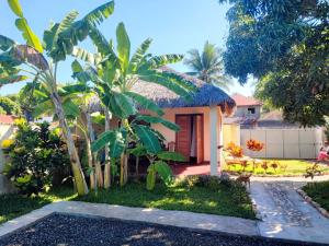 a small house with a grass roof at Chez Rosa in Nosy Be