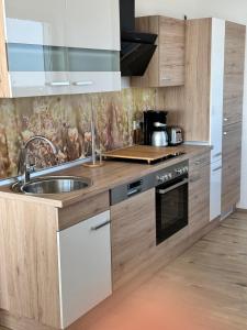 a kitchen with a sink and a stove at Ebbe u Flut Bremerhaven in Bremerhaven
