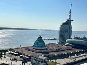 a view of a city with a building next to the water at Ebbe u Flut Bremerhaven in Bremerhaven