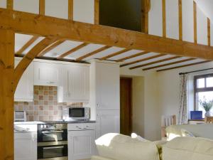 a kitchen with white cabinets and a counter top at Brandy's Barn in Middleham