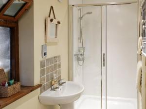 a bathroom with a sink and a shower at Brandy's Barn in Middleham