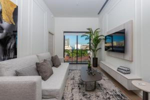 a living room with a couch and a table at The Avenue Coral Gables in Miami