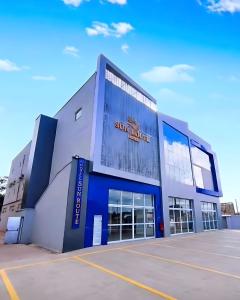 a large building with the sun signs on it at Sun Route Hotel in Cabo de Santo Agostinho