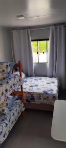 a bedroom with two beds and a window at Studio Container Morano Calabro in Florianópolis