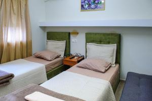 a room with two beds and a table in it at Hotel Makedonia in Évzonoi