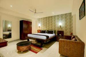 a hotel room with a bed and a couch at Hotel O Riddhinn6 in Jalandhar