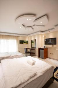 a large bedroom with two beds and a desk at Nilotique in Cairo