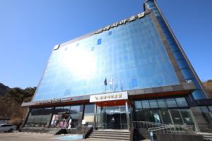 a large glass building with stairs in front of it at Incheon Freshia Hotel in Incheon