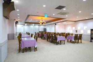 a dining room with purple tables and chairs at Incheon Freshia Hotel in Incheon