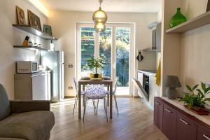 a living room with a table and a refrigerator at Macaia Family Apartment with AC in Vernazza +33 photos