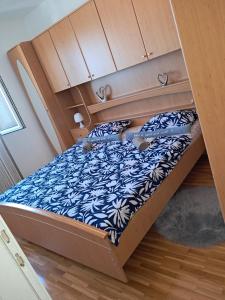 a bunk bed with a blue and white bedsheet at Apartman Antonio in Gospić