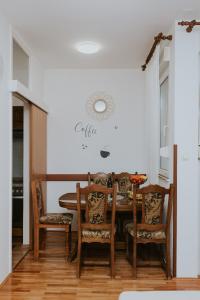a dining room with a table and chairs at Apartman Antonio in Gospić +8 photos