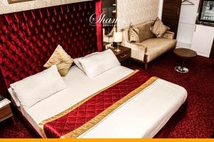 a hotel room with a bed and a couch at Shams Albasra Hotel in Al Başrah