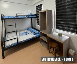 a room with two bunk beds and a desk at E&E Residence in Locsin