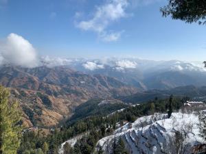 a view of a mountain range with snow at Willow Winds Home Stay in Theog +18 photos