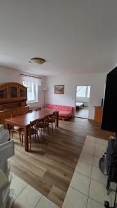 a living room with a table and chairs and a couch at Pension Úsvit in Podkopná Lhota