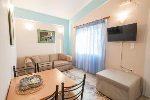 a living room with a table and a couch at Alkiones in Platy