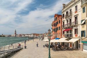 a group of buildings on a pier next to the water at Porta da mar in Venice