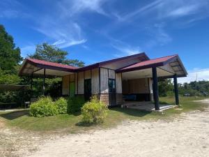 a small house with a roof on top of it at Papalu Villa in Kuala Penyu