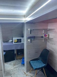 a small room with a chair and a microwave at Central Location Stay in Chişinău