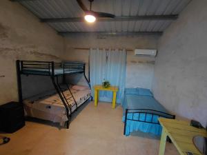 a room with two bunk beds and a table at Sansalo Lounge Capira in Lídice +29 photos