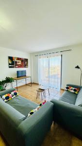 a living room with two beds and a couch at Apartamentos Ajabo Adeje in Adeje