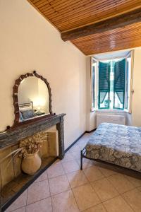 a bedroom with a bed and a mirror on the wall at Macaia Village Life Room with AC #1 in Vernazza