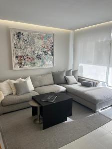 a living room with a couch and a table at Minerva Beach in Port d'Alcudia +42 photos