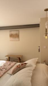 a bedroom with a bed and a wooden table at La Césarine in Nyons