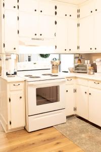 a kitchen with white cabinets and an oven at The Tackle Box in Guntersville