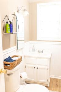 a bathroom with a white toilet and a sink at The Tackle Box in Guntersville +9 photos