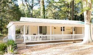 a small yellow house with a white porch at The Tackle Box in Guntersville