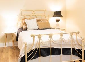a bedroom with a white bed and a lamp at The Tackle Box in Guntersville