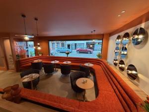 een eetkamer met een tafel en stoelen en een auto bij Hotel De Hofkamers in Oostende