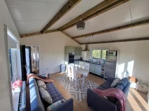 a living room with a blue couch and a table at Countryside Cabin in Charlestown