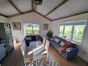 a living room with a blue couch and a table at Countryside Cabin in Charlestown