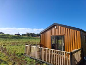 a small building with a fence in a field at Countryside Cabin in Charlestown