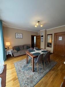 a living room with a table and chairs at Apartamenty Złota Palma in Lądek-Zdrój