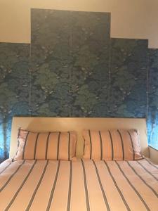 a bedroom with a bed with a painting on the wall at 0.3 Stanze in Trieste