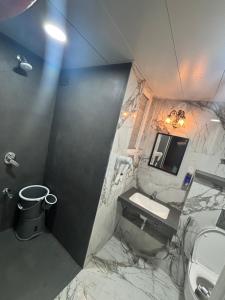 a bathroom with a sink and a toilet at neon viman stays in Pune +13 photos