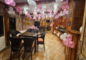 a room with a bunch of pink and white balloons at The Oaktree House in Shimla