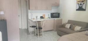 a small kitchen with a bar and a couch in a room at elia patra apartment 2 in Patra