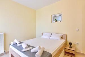 a bedroom with a bed with white towels on it at Hemera House Posidi H3 in Possidi +26 photos