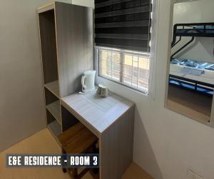 a room with a desk with a mug on it at E&E Residence in Locsin +1 photo