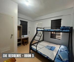 a bedroom with a bunk bed in a room at E&E Residence in Locsin